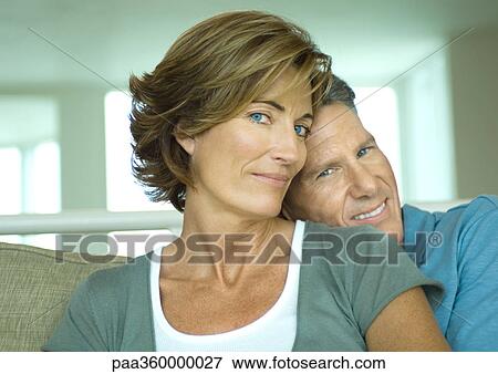 Stock Photo - Mature couple, man resting head on woman's shoulder. Fotosearch