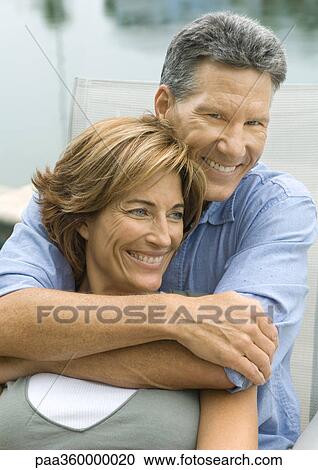 Mature couple, man with arms around woman View Large Photo Image Stock Image - Mature couple, man with arms around woman. Fotosearch