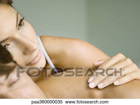 Stock Photography - Woman lying on man's back. Fotosearch