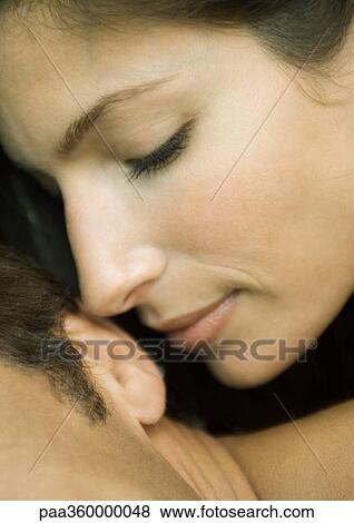 Woman's face near man's ear View Large Photo Image Stock Photo - Woman's face near man's ear. Fotosearch