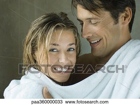 Stock Image - Young couple drying off. Fotosearch