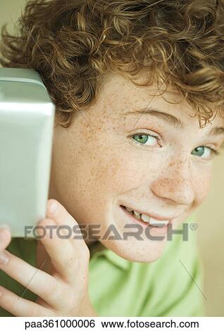 Stock Photograph - Boy holding up present. Fotosearch