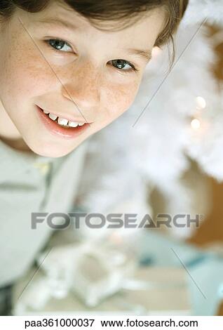Boy smiling at camera, high angle view View Large Photo Image Stock Photo - Boy smiling at camera, high angle view. Fotosearch