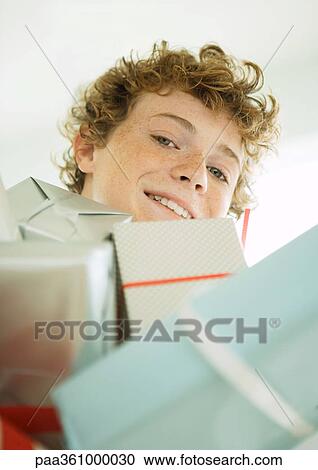 Boy with pile of presents View Large Photo Image Stock Image - Boy with pile of presents. Fotosearch
