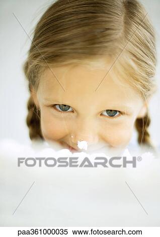 Stock Photography - Girl biting into cake. Fotosearch