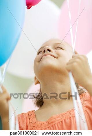 Girl holding balloons View Large Photo Image Stock Image - Girl holding balloons. Fotosearch