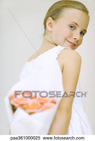 Girl holding bouquet of flowers behind back View Large Photo Image Stock Photography - Girl holding bouquet of flowers behind back. Fotosearch