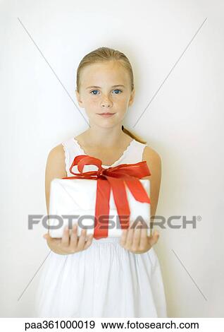 Girl holding present, front view View Large Photo Image Stock Photo - Girl holding present, front view. Fotosearch