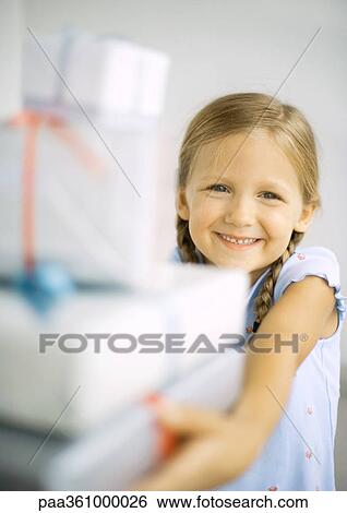 Girl holding stack of presents View Large Photo Image Stock Photograph - Girl holding stack of presents. Fotosearch