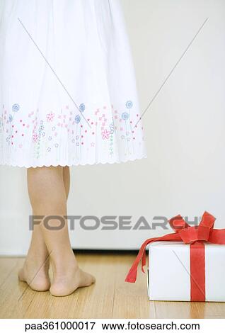 Girl standing next to present, waist down View Large Photo Image Stock Photo - Girl standing next to present, waist down. Fotosearch