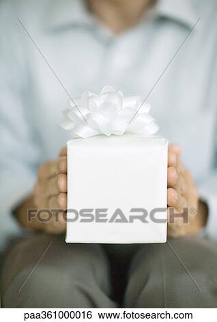 Man holding out gift View Large Photo Image Stock Photograph - Man holding out gift. Fotosearch