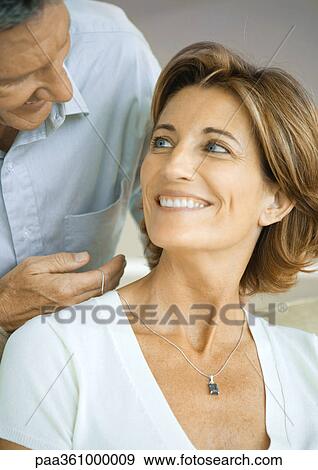 Man putting necklace on wife View Large Photo Image Stock Photo - Man putting necklace on wife. Fotosearch