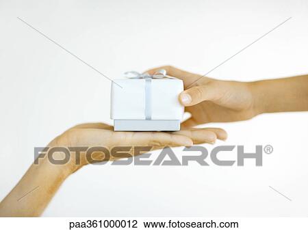 One person handing second person gift, close-up of hands View Large Photo Image Stock Image - One person handing second person gift, close-up of hands. Fotosearch