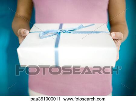 Woman holding out gift, mid section View Large Photo Image Stock Image - Woman holding out gift, mid section. Fotosearch