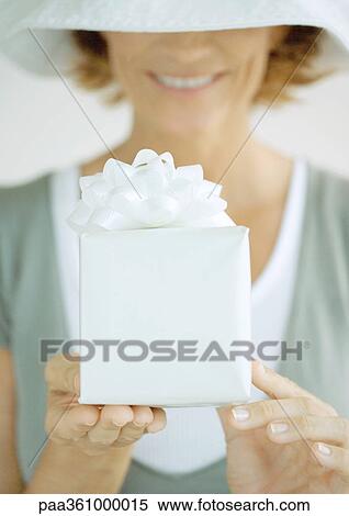 Woman holding out gift View Large Photo Image Stock Photography - Woman holding out gift. Fotosearch