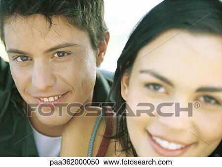 Couple smiling, focus on man in background View Large Photo Image Stock Image - Couple smiling, focus on man in background. Fotosearch