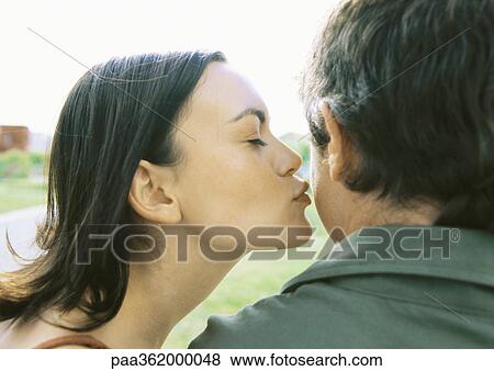 Woman kissing man's cheek View Large Photo Image Stock Photo - Woman kissing man's cheek. Fotosearch
