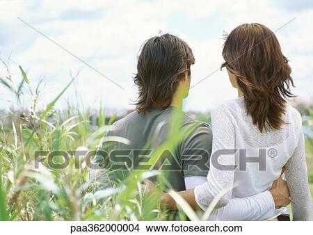 Young couple embracing outdoors, rear view View Large Photo Image Picture - Young couple embracing outdoors, rear view. Fotosearch