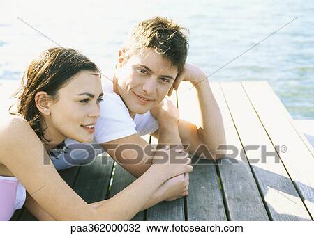 Young couple lying on dock View Large Photo Image Stock Image - Young couple lying on dock. Fotosearch