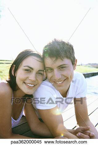 Young couple lying on dock View Large Photo Image Stock Photography - Young couple lying on dock. Fotosearch
