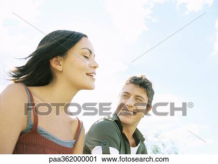 Young couple outdoors View Large Photo Image Stock Image - Young couple outdoors. Fotosearch