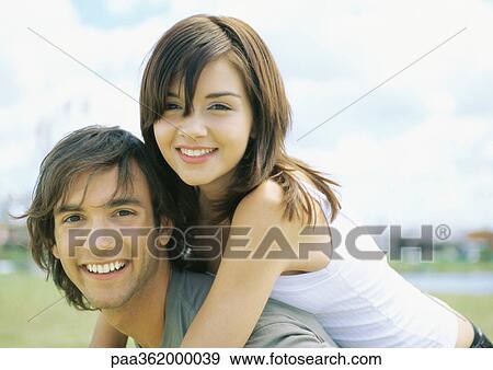 Young couple smiling View Large Photo Image Stock Photo - Young couple smiling. Fotosearch