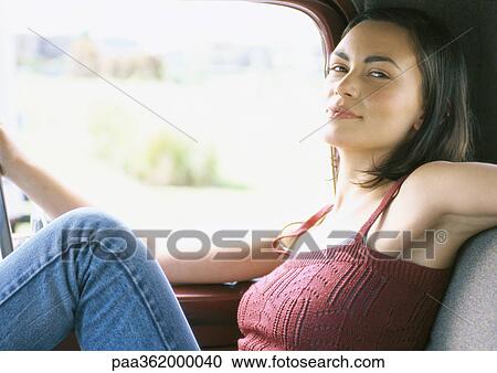 Young woman sitting in car View Large Photo Image Stock Image - Young woman sitting in car. Fotosearch