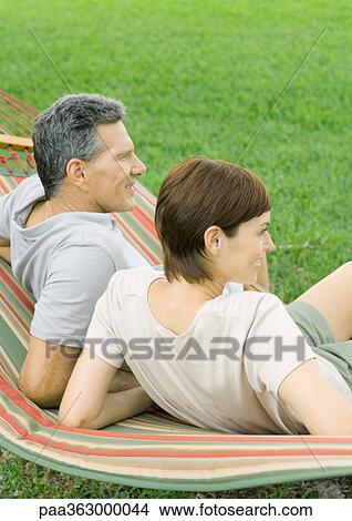 Couple lounging in hammock View Large Photo Image Picture - Couple lounging in hammock. Fotosearch