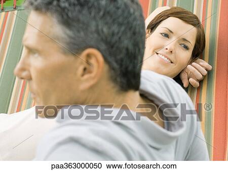 Couple lounging in hammock View Large Photo Image Stock Image - Couple lounging in hammock. Fotosearch