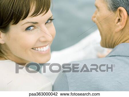 Couple, woman looking over shoulder at camera, close-up View Large Photo Image Stock Image - Couple, woman looking over shoulder at camera, close-up. Fotosearch