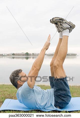 Man doing sit-ups by edge of water View Large Photo Image Stock Image - Man doing sit-ups by edge of water. Fotosearch