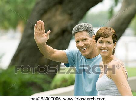 Stock Photograph - Mature couple, man waving. Fotosearch
