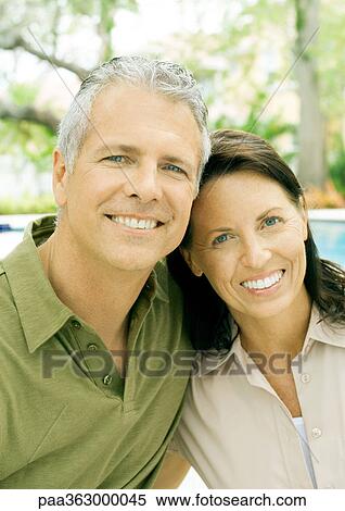 Mature couple smiling, portrait, pool in background View Large Photo Image Stock Photography - Mature couple smiling, portrait, pool in background. Fotosearch