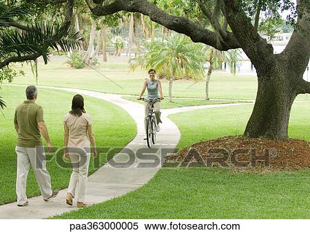 Stock Photography - Mature couple walking on walkway. Fotosearch