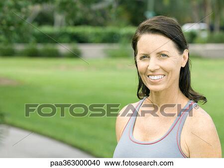 Stock Image - Mature woman in workout clothes, portrait. Fotosearch