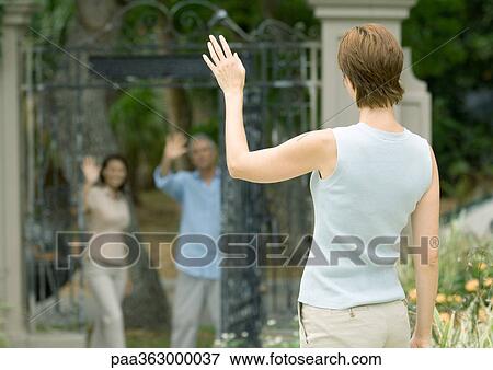Stock Photo - Woman waving to neighbors. Fotosearch