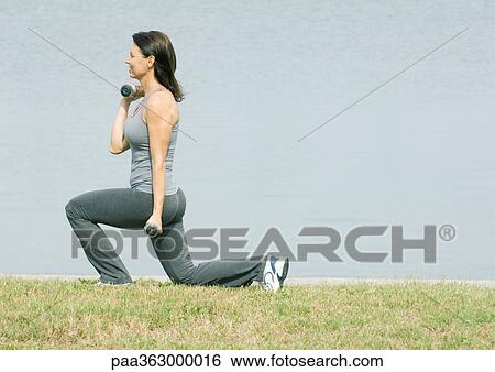 Woman working out by edge of water View Large Photo Image Stock Photograph - Woman working out by edge of water. Fotosearch