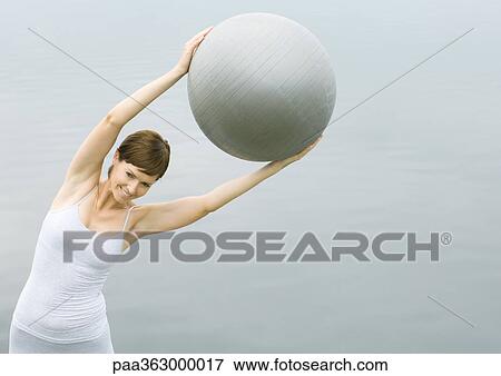 Woman working out with fitness ball View Large Photo Image Stock Photo - Woman working out with fitness ball. Fotosearch