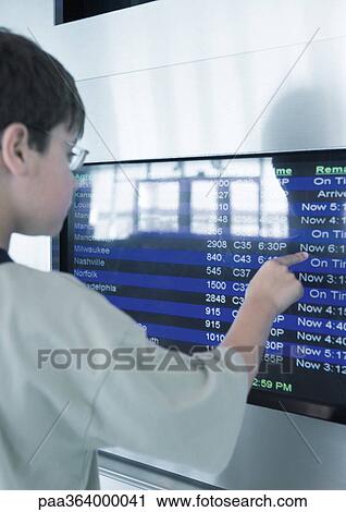 Boy touching departure board screen View Large Photo Image Stock Image - Boy touching departure board screen. Fotosearch