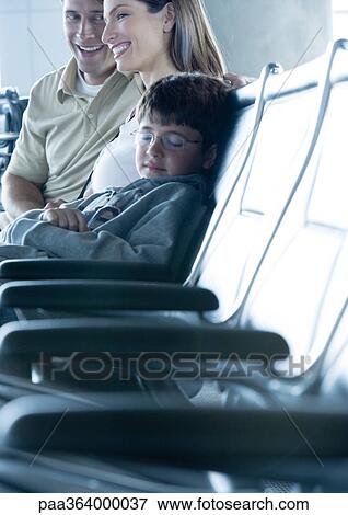 Family sitting in airport lounge View Large Photo Image Stock Photo - Family sitting in airport lounge. Fotosearch