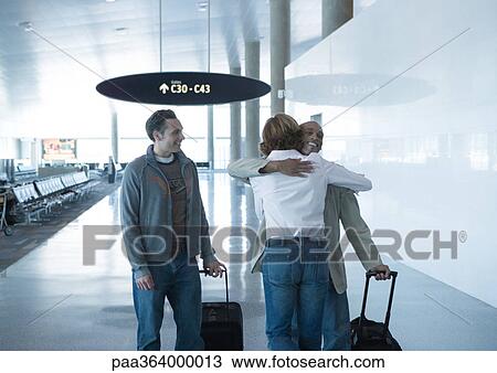 Man and woman hugging in airport View Large Photo Image Stock Image - Man and woman hugging in airport. Fotosearch