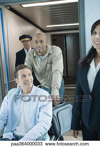Man in wheelchair being pushed in airport View Large Photo Image Stock Image - Man in wheelchair being pushed in airport. Fotosearch