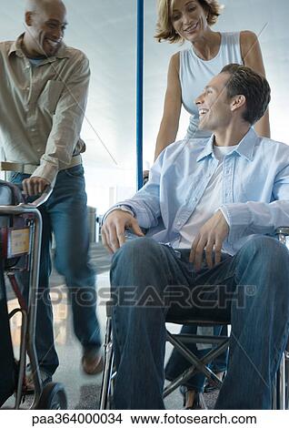 Man in wheelchair talking to friends View Large Photo Image Picture - Man in wheelchair talking to friends. Fotosearch