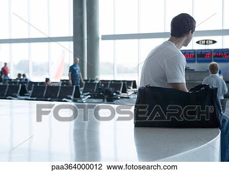 Man waiting near departure gate View Large Photo Image Stock Image - Man waiting near departure gate. Fotosearch