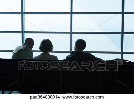 Silhouette of travelers in airport lounge View Large Photo Image Picture - Silhouette of travelers in airport lounge. Fotosearch