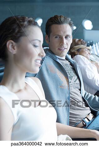 Travelers chatting in airport lounge View Large Photo Image Stock Image - Travelers chatting in airport lounge. Fotosearch