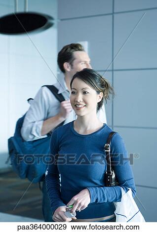 Travelers in airport View Large Photo Image Stock Photo - Travelers in airport. Fotosearch