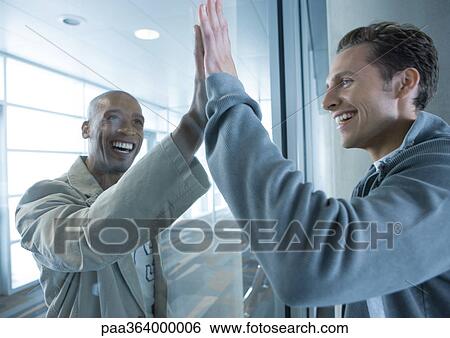 Two men putting palms together on either side of window View Large Photo Image Stock Photograph - Two men putting palms together on either side of window. Fotosearch