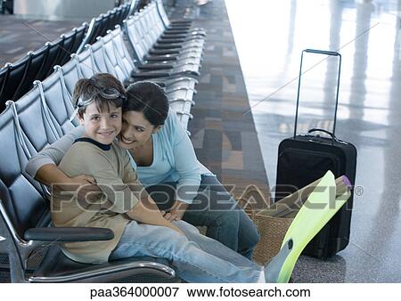 Woman sitting with son in airport lounge View Large Photo Image Stock Photo - Woman sitting with son in airport lounge. Fotosearch