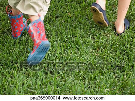Two children running across grass, close-up of feet View Large Photo Image Picture - Two children running across grass, close-up of feet. Fotosearch